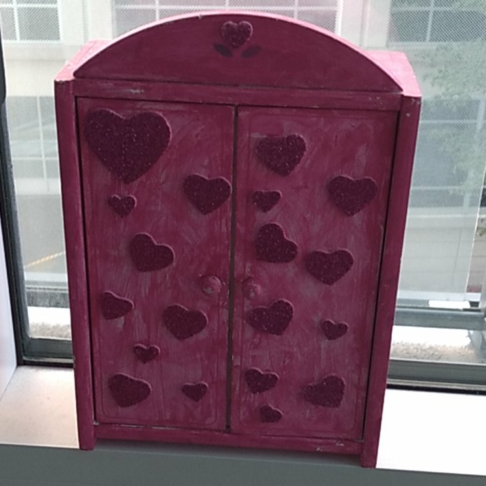 A hand painted pink doll closet for little girls